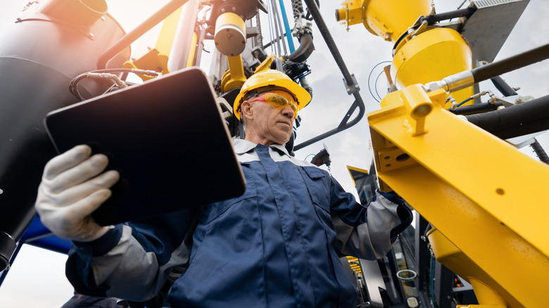 A person operating an oil rig.