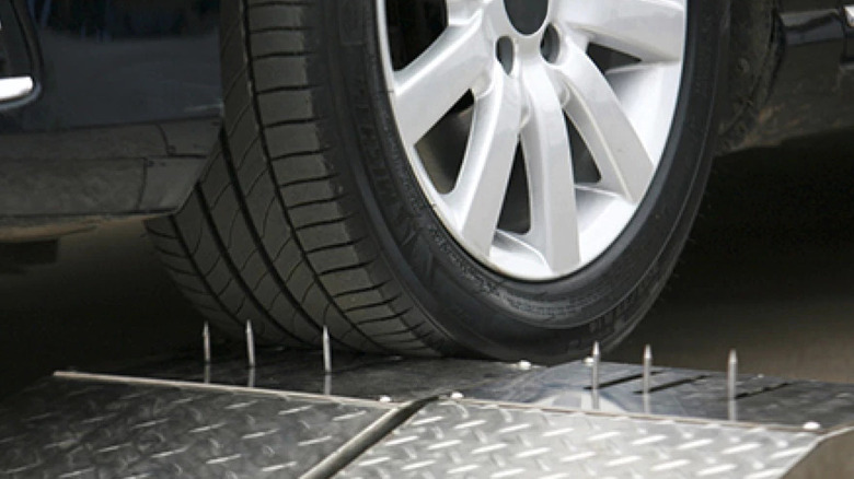 A tire undergoes a puncture test