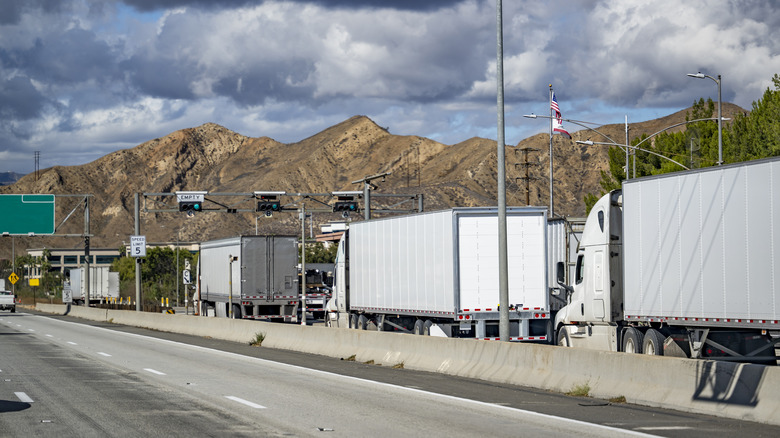 A California Weigh Station With Several Trucks Waiting In Line