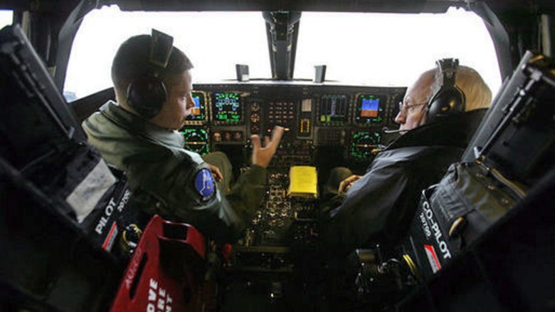 Dick Cheney sits inside the cockpit of a B-2 Stealth Bomber with a pilot