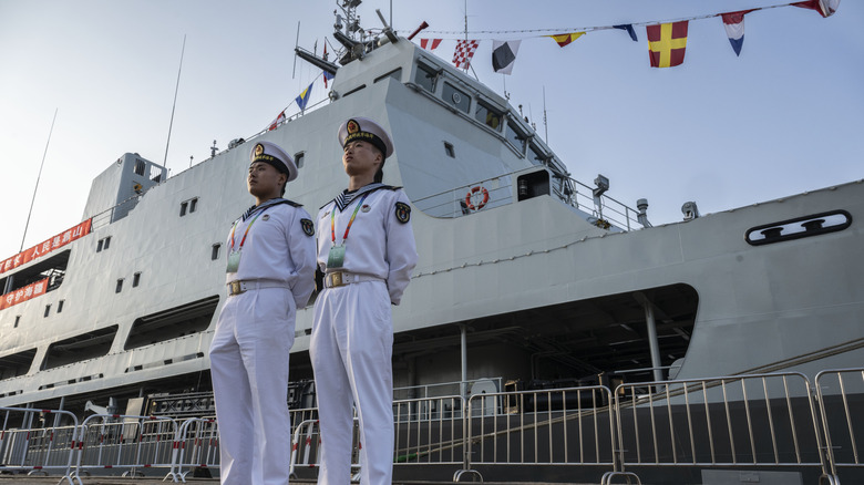 Chinese sailors stand next to a submarine rescue ship Hongzehu from the PLA Navy.