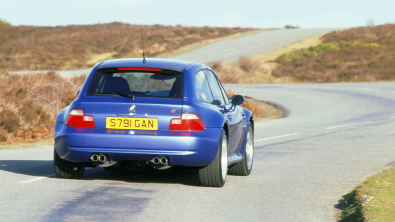 Rear view of blue BMW Z3 M Coupe on country road.
