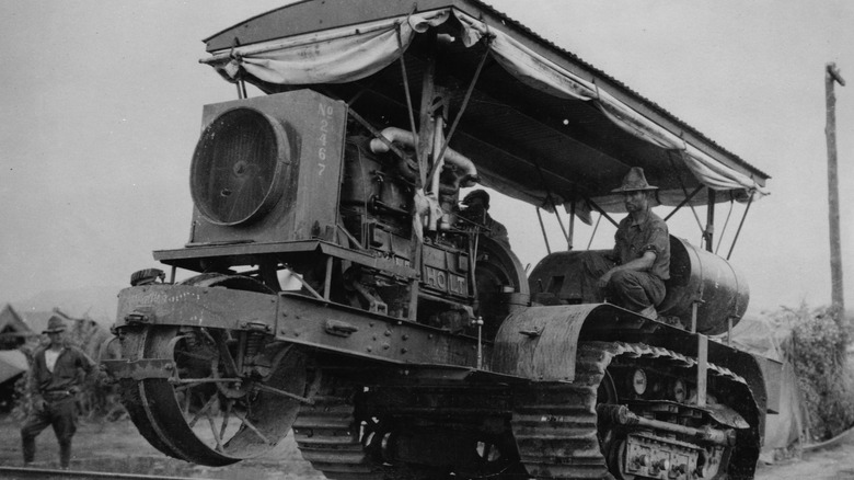 US army soldiers drive a Holt caterpillar tractor