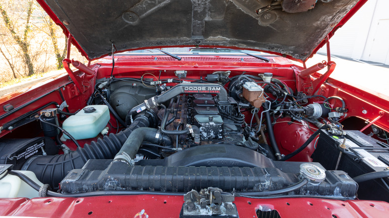 A Cummins Turbo Diesel engine under the hood of a red Dodge Ram