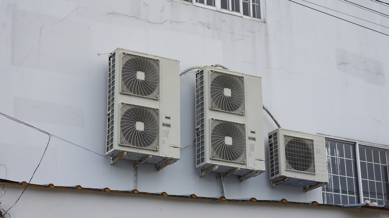 Air conditioning units on a wall outside.