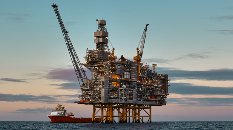 Jack-up oil rig in the ocean at dusk