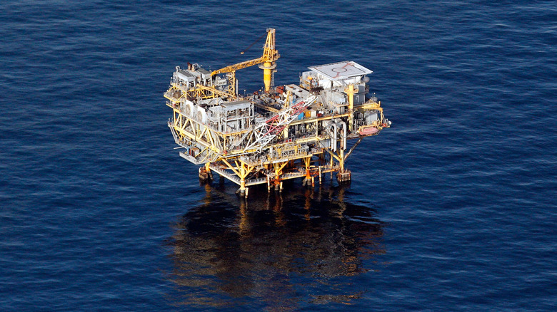 A zoomed out aerial photo of a single offshore oil rig.