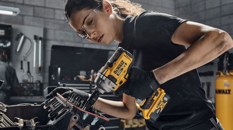 A person using a DeWalt impact wrench.