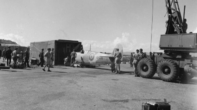 A World War II aircraft coming out of a crate