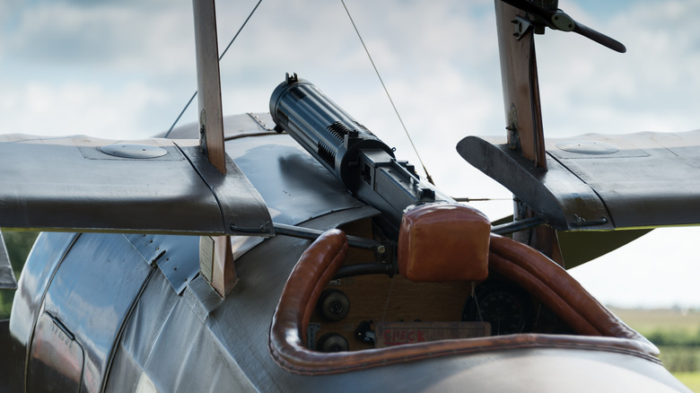 A mounted machine gun in a WWI fighter plane cockpit.
