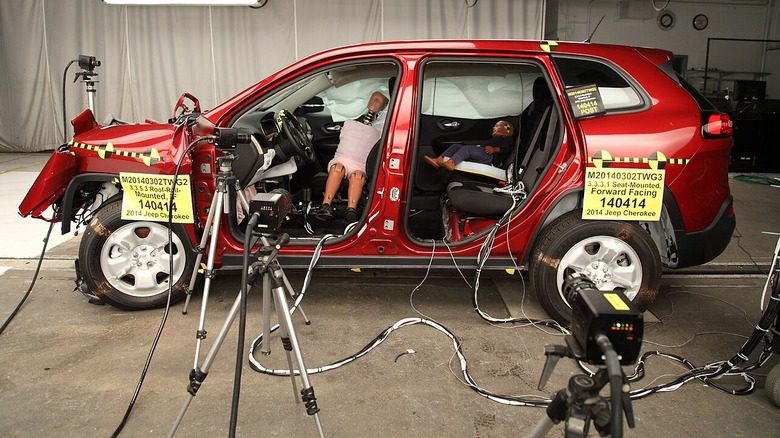 National Highway Traffic Safety Administration uses two dummies sitting inside a Jeep Cherokee to test the deployment of side airbags.