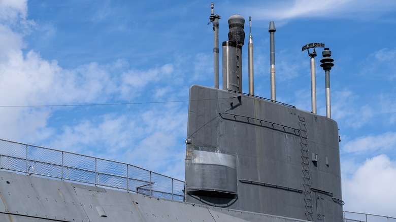 The sail of a diesel-electric submarine against a blue sky