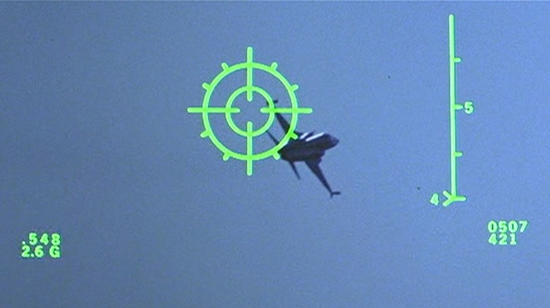 A targeting crosshair looming over a black F-5 Tiger