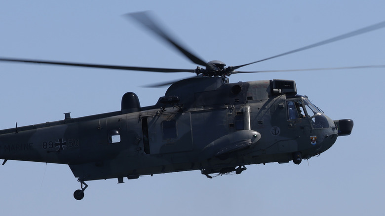 A Sea King helicopter above ocean 