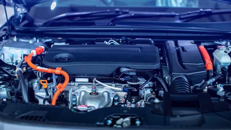 The open hood of a car showcasing the hybrid electric engine.