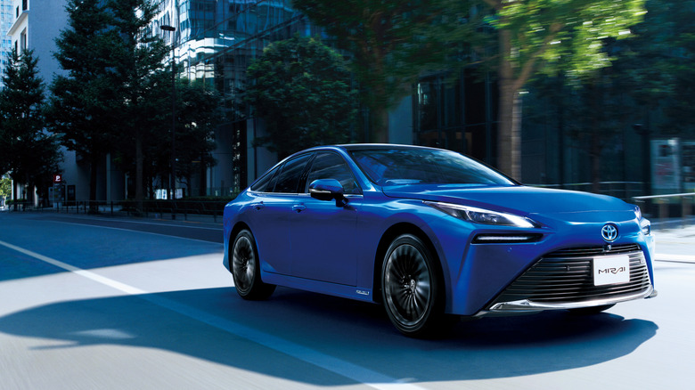 2025 Toyota Mirai driving on road, front-right view