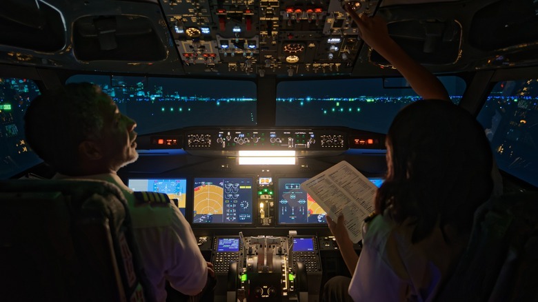 Pilots in the cockpit at night