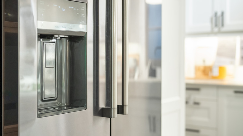 Close-up of a shiny stainless steel refrigerator with two doors.