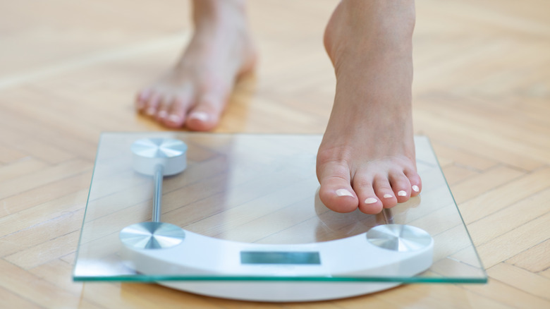 Woman stepping onto scale