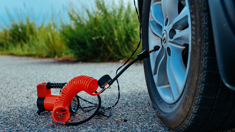 Small air pump inflating tire