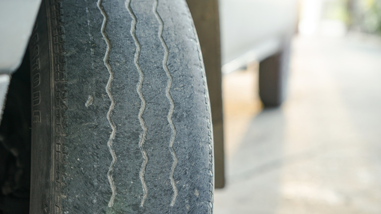 A close-up of a very worn Bridgestone tire on an unidentified vehicle