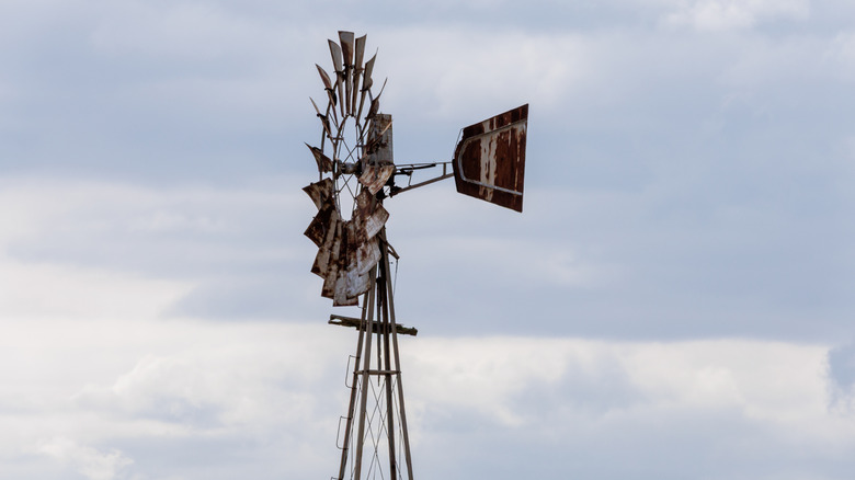 A side view of a weathered wind pump