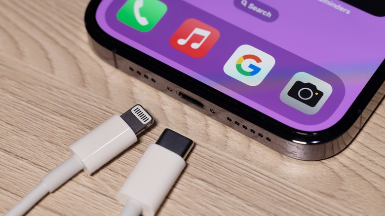 iPhone with a cable with a Lightning connector on one end and a USB-C connector on the other end