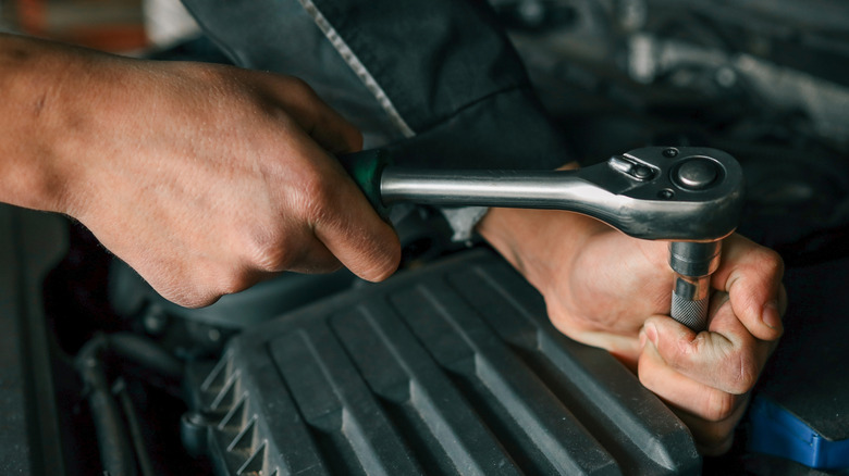 Mechanic using a ratchet tool