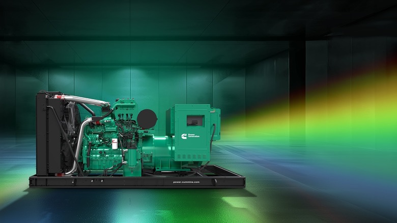 Cummins heavy-duty engine on stand with rainbow of colors emanating from the exhaust, left-side view