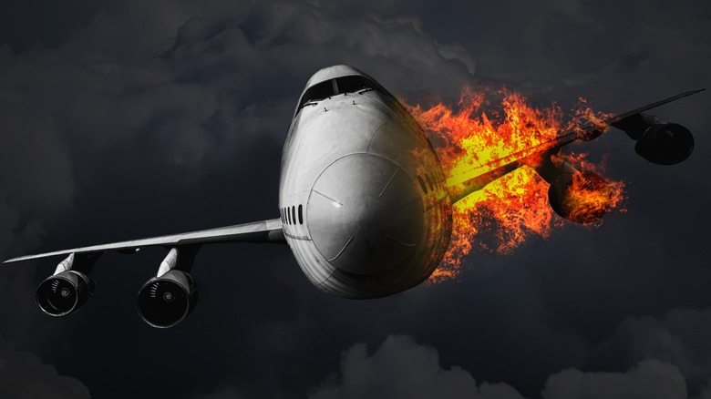 Close up of a plane on fire mid-flight