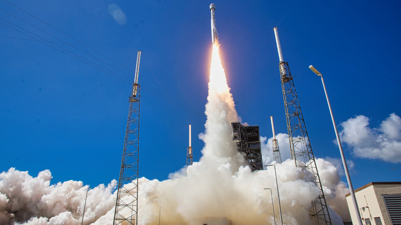 Rocket launching against a bright blue sky