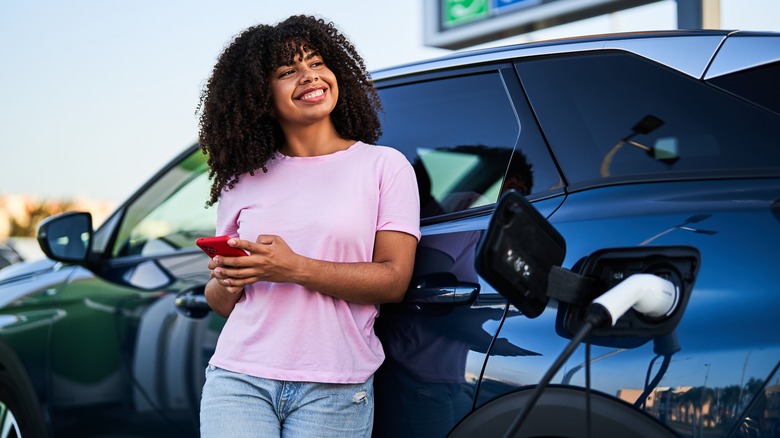 EV driver waiting for her car to charge