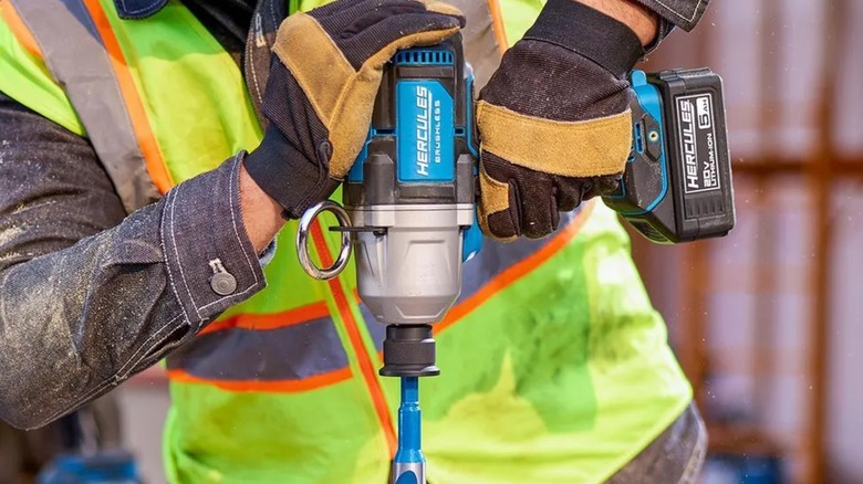A person using a Hercules impact wrench on a jobsite.