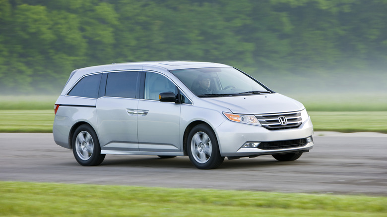 2012 Honda Odyssey on the road, front 3/4 view, silver exterior