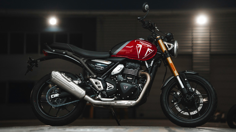 A Triumph Speed 400 with a red tank, side view