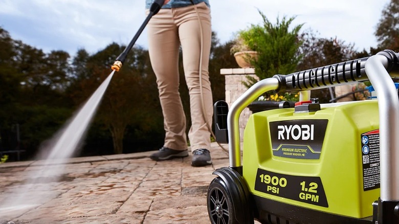 Ryobi 1900 PSI pressure washer model being used to wash sidewalk