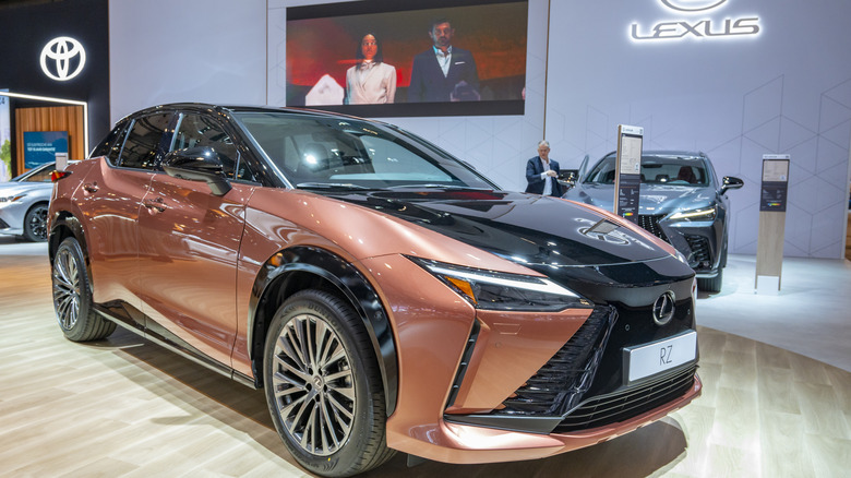A bronze Lexus RZ 450e on display at an auto show