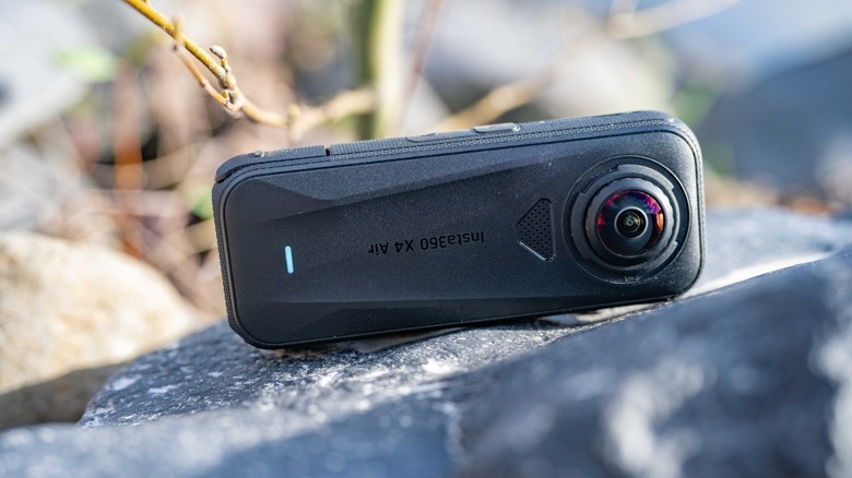 The Insta360 X4 Air sitting on a rock.