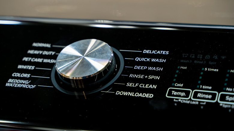 Close up of washing machine control panel.
