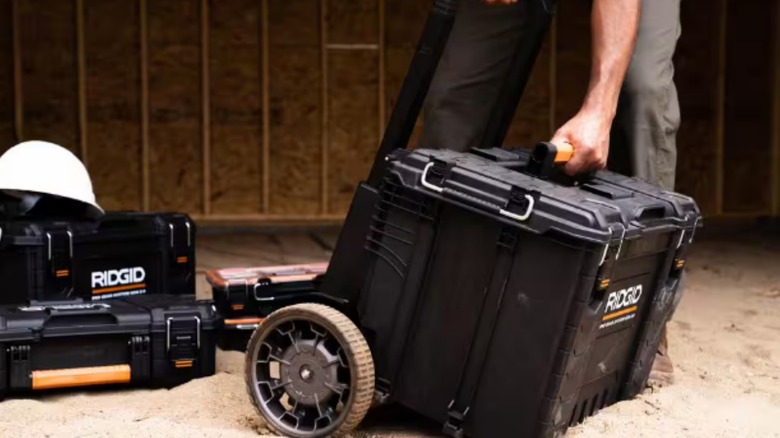 a person with a ridged modular rolling toolbox and additional ridged accessories in the background