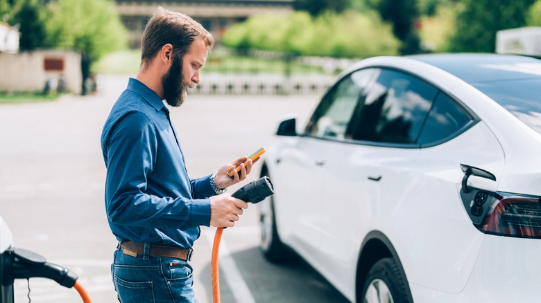 Person charging electric car