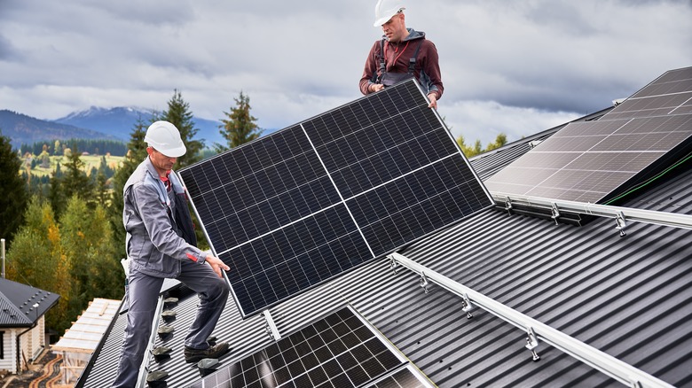 men installing solar panels