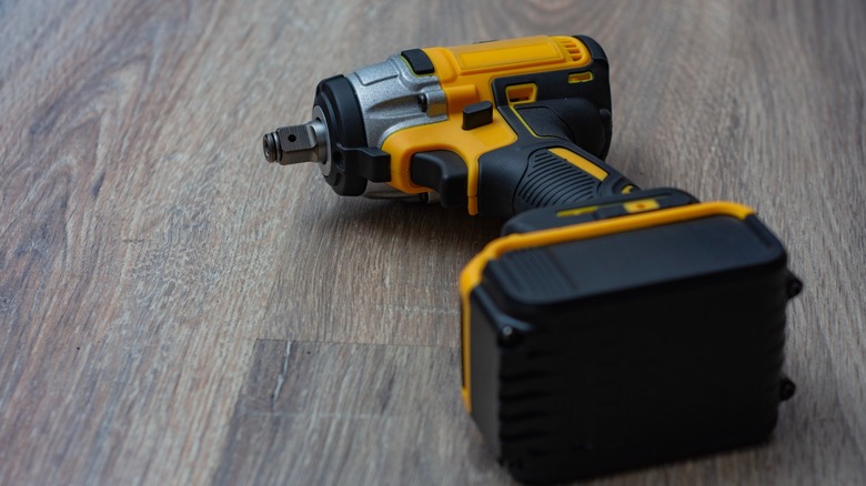Cordless impact wrench placed on a wooden board