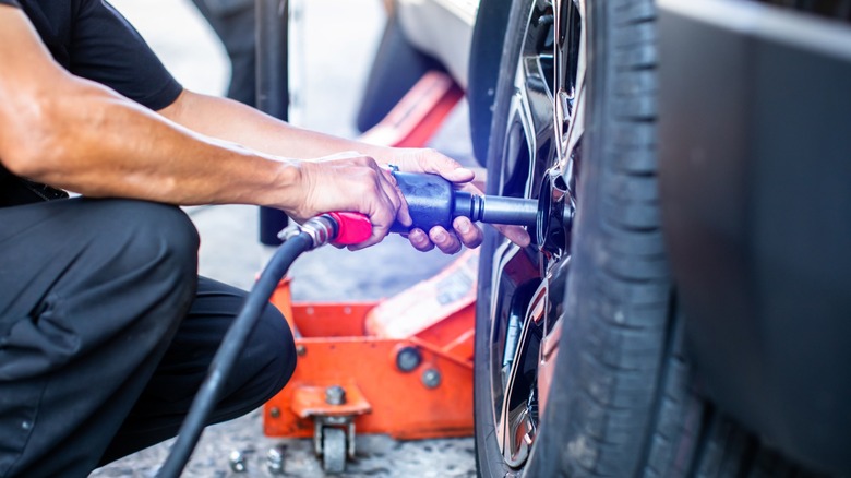 Impact wrench being used on car tire