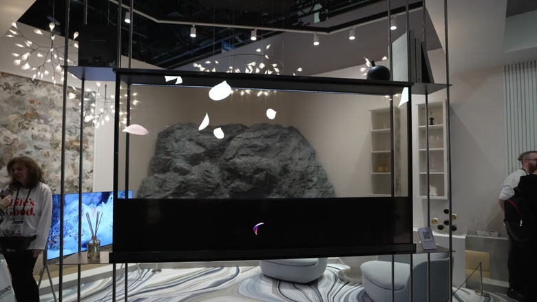 Black screen in the LG OLED T TV rolling down to reveal the background