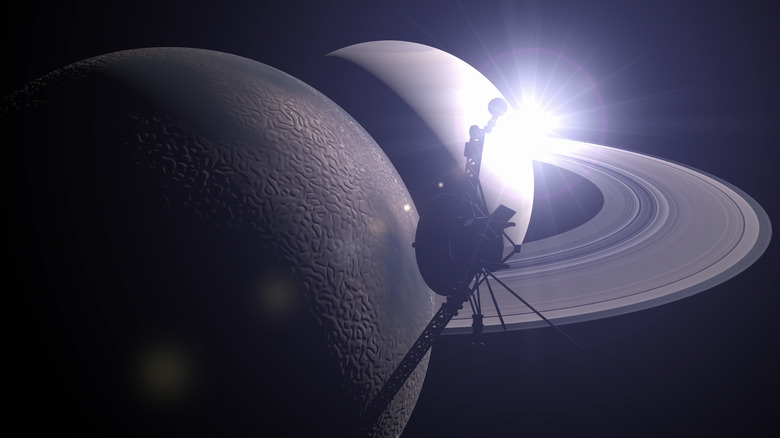 A render of Voyager 2 orbiting Saturn and its moon Titan, passing through the rings of Saturn.