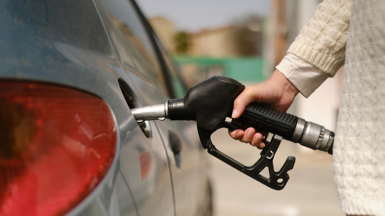 person fueling car
