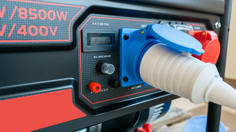 A picture showing a cord being plugged into a portable generator