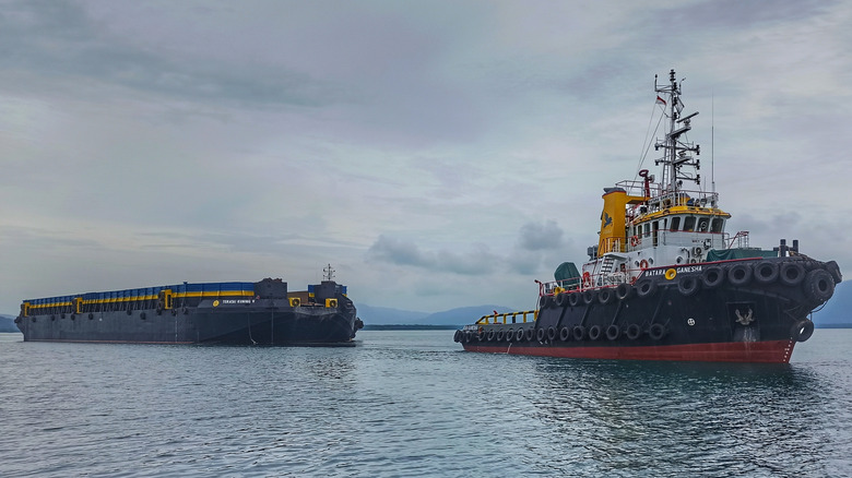 A tugboat pulling a barge.