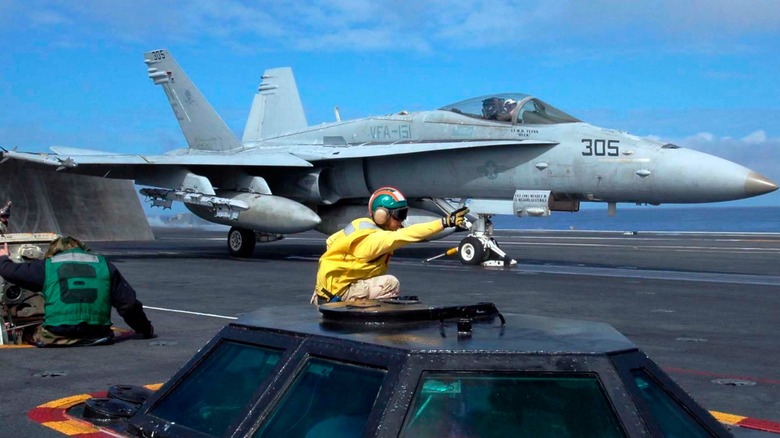 An F-A-18C Hornet preparing to launch off the USS Abraham Lincoln